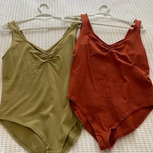 Burnt red and army green bodysuits.